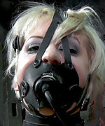 Fixed with leather straps, tightly gagged, dildoed